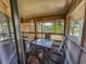 The screened in patio offers a place to relax with a table and chairs at 410 Melrose Pl. # 219, Myrtle Beach, SC 29572