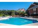 Community pool surrounded by lounge chairs and tables at 410 Melrose Pl. # 219, Myrtle Beach, SC 29572