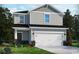 Charming two-story home with gray siding, a two-car garage, and manicured landscaping at 4807 Hopespring St., Myrtle Beach, SC 29579