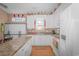 Modern kitchen with white cabinets, a large island, and hardwood floors at 6001-1810 S Kings Hwy., Myrtle Beach, SC 29575
