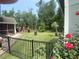 Landscaped backyard featuring a black fence, lush greenery, and roses at 640 Fox Hollow Rd., Murrells Inlet, SC 29576
