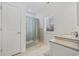 Neutral bathroom with a shower, vanity, and bright window at 640 Fox Hollow Rd., Murrells Inlet, SC 29576