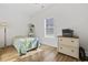 Sunlit bedroom with wood-look flooring, a dresser, and large bright window at 640 Fox Hollow Rd., Murrells Inlet, SC 29576
