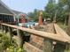 Outdoor deck with dining and lounge areas, overlooking the pool and backyard at 640 Fox Hollow Rd., Murrells Inlet, SC 29576