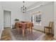 Inviting dining room with a stylish chandelier, wooden table set, and natural light at 640 Fox Hollow Rd., Murrells Inlet, SC 29576