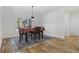 Bright dining area with a wooden table, chairs, and decorative rug near a window at 640 Fox Hollow Rd., Murrells Inlet, SC 29576