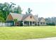 Inviting single-story home with a lush green lawn, front porch, and American flag displayed at 640 Fox Hollow Rd., Murrells Inlet, SC 29576
