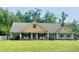 Charming single-story home featuring a well-manicured lawn, rocking chairs and a welcoming front porch at 640 Fox Hollow Rd., Murrells Inlet, SC 29576