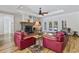 Cozy living room featuring a stone fireplace, wood floors, and French doors to the backyard at 640 Fox Hollow Rd., Murrells Inlet, SC 29576