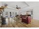 Open-concept living room with stone fireplace, hardwood floors, and direct access to the outdoor pool area at 640 Fox Hollow Rd., Murrells Inlet, SC 29576