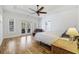 Bright main bedroom with a ceiling fan, wood floors, a bed, and access to a private balcony at 640 Fox Hollow Rd., Murrells Inlet, SC 29576
