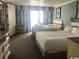 Bright bedroom featuring two beds and a large window with curtains at 7100 N Ocean Blvd. # 1608, Myrtle Beach, SC 29572
