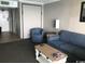 Comfortable living room featuring a blue sofa and chair with table at 7100 N Ocean Blvd. # 1608, Myrtle Beach, SC 29572