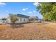 View of backyard showcasing a large grassy area, screened porch, and hammock at 773 Drawbridge Dr., Conway, SC 29526