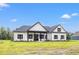 White farmhouse style home with black accents and a large grassy yard at 983 Pisgah Church Rd., Aynor, SC 29511