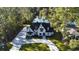 Aerial view of a two-story house with a large driveway and a pond in the background at 101 Green Lake Dr., Myrtle Beach, SC 29572