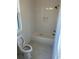Clean bathroom with white tile, a tub, and a toilet at 101 Green Lake Dr., Myrtle Beach, SC 29572
