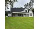 Back of house with large covered patio and grassy backyard at 101 Green Lake Dr., Myrtle Beach, SC 29572