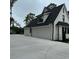 Three-car garage with white doors and black roof at 101 Green Lake Dr., Myrtle Beach, SC 29572