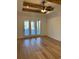 Bright living room with hardwood floors, exposed beams, and access to a patio at 101 Green Lake Dr., Myrtle Beach, SC 29572