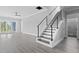 Modern staircase with a cable railing system and dark wood steps at 1103 Bluffton Ct., Myrtle Beach, SC 29579