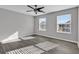 Well lit bedroom with two windows, ceiling fan, and laminate flooring at 116 Brentwood Dr. # E, Murrells Inlet, SC 29576