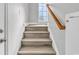 Modern stairs with wood-look flooring and a wooden handrail at 116 Brentwood Dr. # E, Murrells Inlet, SC 29576