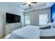 Main bedroom with large TV, dresser, and blue accent wall at 123 Grissett Lake Dr., Conway, SC 29526