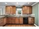 Well-equipped kitchen featuring wooden cabinetry and granite countertops at 133 Pottery Landing Dr., Conway, SC 29527