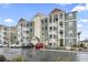 Exterior of a three-story building with multiple units, ample parking, and a well-maintained appearance at 157 Ella Kinley Circle # 303, Myrtle Beach, SC 29588