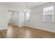 Bright dining room with hardwood floors and modern light fixture at 219 Marauder Dr., Longs, SC 29568