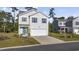 Two-story house with a two car garage and front yard at 219 Marauder Dr., Longs, SC 29568