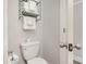 Small bathroom with toilet and shelving unit at 2310 North Ocean Blvd. # 201, Myrtle Beach, SC 29577
