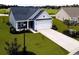 Two-story house with gray and blue siding, white garage door, and landscaping at 260 Red Maple Loop, Longs, SC 29568