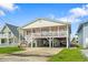 Elevated beach home with spacious deck and parking underneath at 327 55Th Ave. N, North Myrtle Beach, SC 29582