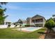 Large backyard showcases a beautiful pool and the home's exterior from a serene vantage point at 352 Sea Marsh Rd., Murrells Inlet, SC 29576