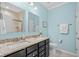 Bathroom featuring double sinks with granite countertops, tiled floors, and a framed mirror at 3716 Mackevans Ct., Myrtle Beach, SC 29579