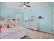 Charming bedroom with a white dresser, a window, and a comfortable bed with decorative pillows at 3716 Mackevans Ct., Myrtle Beach, SC 29579