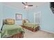 Light-blue bedroom featuring two twin beds with patterned bedding, and natural light from a window at 3716 Mackevans Ct., Myrtle Beach, SC 29579
