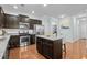 Modern kitchen features stainless appliances, granite countertops, dark cabinets, and a kitchen island at 3716 Mackevans Ct., Myrtle Beach, SC 29579