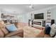 Open-concept living room featuring hardwood floors, an entertainment center, and a cozy seating area at 3716 Mackevans Ct., Myrtle Beach, SC 29579