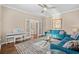Comfortable living room with hardwood floors, blue sofa, and glass table, with a piano in the background at 3716 Mackevans Ct., Myrtle Beach, SC 29579