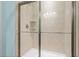 Shower enclosure featuring tiled walls, a shower head, and a built-in shower seat for convenience at 3716 Mackevans Ct., Myrtle Beach, SC 29579