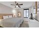 Cozy bedroom with fan and white furniture at 4111 S Ocean Blvd. # 701, North Myrtle Beach, SC 29582