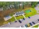 Aerial view of community clubhouse, putting green, and parking area at 448 Red River Ct. # 39H, Myrtle Beach, SC 29579