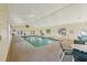 Indoor swimming pool with seating area and large windows at 448 Red River Ct. # 39H, Myrtle Beach, SC 29579
