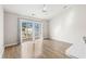 Living room with wood flooring and sliding glass doors to a balcony at 448 Red River Ct. # 39H, Myrtle Beach, SC 29579