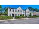 Gray townhouses with a traditional design, ample parking, and lush landscaping at 4541 Girvan Dr. # A, Myrtle Beach, SC 29579