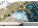 High-angle view of resort pools, deck chairs, and surrounding landscape at 4800 S Ocean Blvd. # 1007, North Myrtle Beach, SC 29582