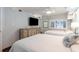 Bedroom with two twin beds, TV, and coastal-themed decor at 4800 S Ocean Blvd. # 1007, North Myrtle Beach, SC 29582